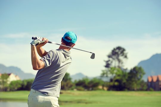 Golfer hitting golf shot